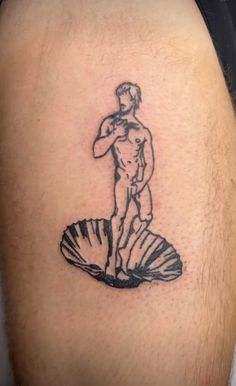 a man with a tattoo on his arm is standing next to a shell and holding a baseball bat