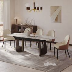 a dining room table with chairs and a rug on the floor in front of it