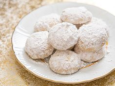 powdered sugar cookies on a white plate