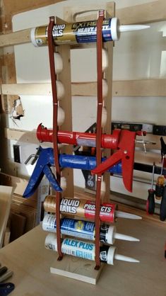 a wooden table topped with lots of tools on top of it's sides and two tubes attached to each other