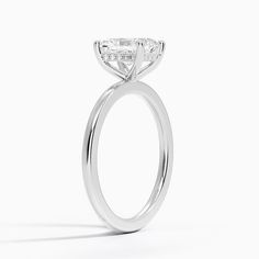 a close up view of a diamond engagement ring on a white background with the center stone in