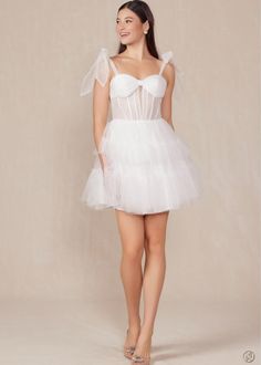 How dreamy is this White Tulle A-Line Mini?! Tulle Tie straps meet a ruched bandeau style bust and corset style bodice and flow into a layered tulle skirt. This dress will have you twirling on the dance floor all night long! Finished with an invisible zipper. Final Sale. Looking for a different size? Message us to inquire about availability to special order in sizes 00-16, don't forget to include the date of your event! Prom Corset Dress With Pleated Bodice And Spaghetti Straps, Mini Tulle Dresses With Corset Back, Strapless Dresses With Fitted Bodice In Tulle, Mini Tulle Dress With Corset Back, Prom Season Tulle Corset With Lined Bodice, Homecoming Tulle Corset Dress With Sweetheart Neckline, Strapless Sweetheart Neckline Dress With Ruffles For Debutante Ball, Fitted Tulle Strapless Dress With Corset Back, Prom Corset With Tulle Skirt And Fitted Bodice