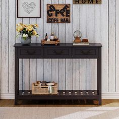 a table with two drawers and some pictures on the wall