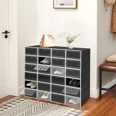 the shoe rack is organized with plastic bins