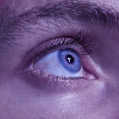 a man's blue eye is seen in this image