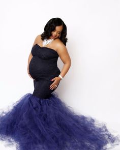 This Sexy Mama Maternity strapless lace tulle maternity gown is absolutely breathtaking. The dress is constructed from premium stretch material on the bodice with a stretchy lace layer over top. The bottom is handcrafted with tulle to create pure elegance that is perfect for both indoor and outdoor shoots. This design is perfect for your maternity photoshoot or any special occasion.  #maternitygown #maternitydresses #bestmaternity #bumpit #prego #maternitysession #maternityphotography Strapless Tulle Gown With Detachable Train, Strapless Lace Gown With Sweep Train, Maternity Fitted Gown With Tulle Skirt, Fitted Maternity Gown With Tulle Skirt, Fitted Tulle Maternity Dress For Wedding, Fitted Tulle Maternity Wedding Dress, Elegant Fitted Tulle Maternity Dress, Elegant Maternity Gown With Tulle Skirt, Mermaid Maternity Dress