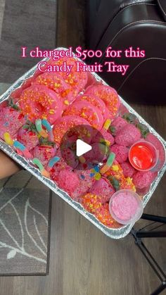 someone is holding a tray with candy and sprinkles on it that says i changed $ 500 for this candy fruit tray