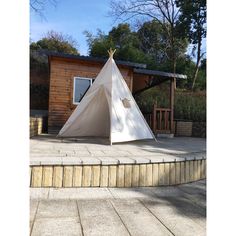 a white teepee sitting on top of a patio