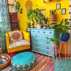 a living room filled with furniture and lots of plants