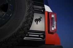 the tail end of a red truck with a black and white bull decal on it