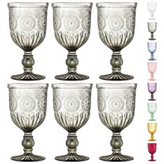 six glass goblets with different designs and colors on each one, all sitting side by side