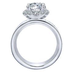 a white gold engagement ring with an oval diamond center