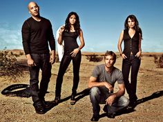 the cast of entourage posing for a photo in the desert with their shadows on the ground