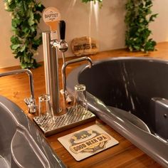 a bathroom with a bathtub, sink and soap dispenser