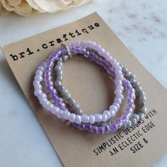 Perfect for the purple lover in your life, this stretch seed bead set delivers all the lavender vibes. Lilacs and iridescence create the perfect combo for all your pastel dreams. (Bracelet sold as a set)Size shown: 7 inches Strung on pre-stretched bracelet material. SIZINGThe sizing chart is the standard for stretch bracelets. Since material is pre-stretched there is some leeway or give as far as how the bracelet fits on your wrist. TIP FOR MEASURING: Best rule of thumb when measuring your wrist Lavender Bracelets With Tiny Beads For Gift, Lavender Beaded Bracelet With Tiny Beads For Gifts, Lavender Beaded Bracelets With Round Beads As Gift, Adjustable Lavender Beaded Bracelets With Tiny Beads, Lavender Beaded Bracelets With Tiny Round Beads, Adjustable Lavender Bracelet With Tiny Beads, Lavender Beaded Bracelets With Spacer Beads, Lavender Beaded Bracelets With Round Spacer Beads, Adjustable Lavender Beaded Bracelets