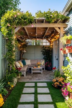 an outdoor living area with flowers and plants