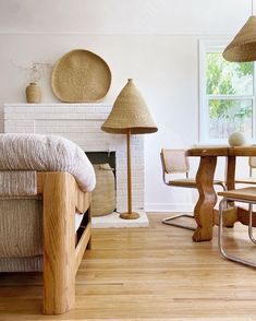 a living room filled with furniture and a fire place next to a fireplace covered in wicker