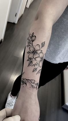 a person with a flower tattoo on their arm