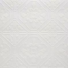 a white wall with an ornate pattern on it