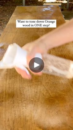 a person using a knife to cut something on a wooden table with words above it that read, want to tone down orange wood in one step?