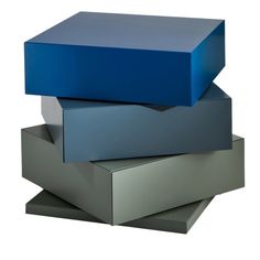 three blue boxes stacked on top of each other in different shapes and sizes, all sitting side by side