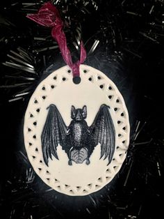 a ceramic ornament with a bat on it