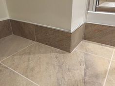 the corner of a bathroom with tile flooring