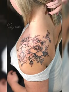 a woman with a flower tattoo on her shoulder