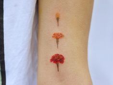 three red flowers on the left side of the arm, with one flower in between them