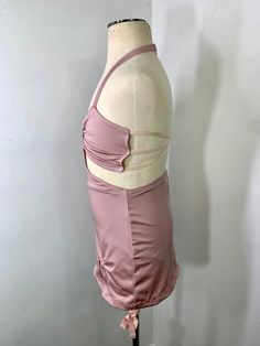 a mannequin wearing a pink dress with straps