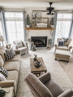 a living room with couches, chairs and a fire place in the middle of it