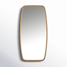 a mirror that is on the wall with a white back ground and light brown trim