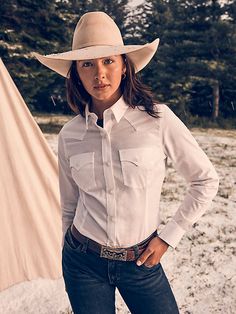 CLASSIC AND ICONIC You’ll look sharp and ready to conquer the world in our Women’s Wrangler Retro® Western Button-Down Shirt. It’s crafted from a comfortable cotton blend with just a hint of stretch. It comes with our signature chest flap pockets and “W” stitching as well as Western yokes, a pointed collar, and a full button closure for easy layering. Get one for every day of the week. Winter Riding Outfits, Carhartt Work Pants, Work Pants Women, Womens Kimono, Riding Outfit, Work Shirts, Clothing Company, College Outfits, Outerwear Women