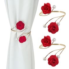 red roses and pearls are attached to the side of a white curtain