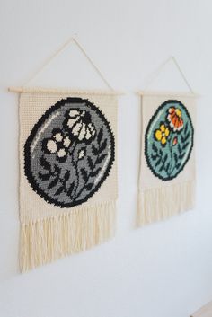 two wall hangings with beaded designs on them