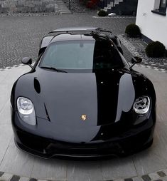 a black sports car parked in front of a building