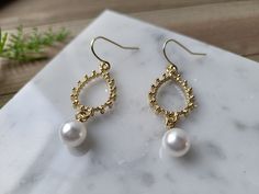 "Such a beautiful pair of Earrings. Perfect Modern minimalist look. The earrings feature a gold plated textured teardrop embellishment and a small faux pearl charm. They are finished with 14k gold plated hooks. The earrings measure about 1.8\" high. Perfect paired with any outfit. These earrings are lightweight and comfy to wear all day! These earrings make perfect gifts! They come mounted on earring display cards, with care instructions printed on the back, and are sealed in a clear plastic bag Bohemian Pearl Wedding Earrings With Ear Wire, Bohemian Round Pearl Earrings For Wedding, Bohemian Gold Pearl Drop Bridal Earrings, Bohemian Gold Bridal Earrings With Pearl Drop, Bohemian Bridal Pearl Drop Earrings, Gold Teardrop Earrings, Earring Bridal, Gold Inspiration, Pearl Stone