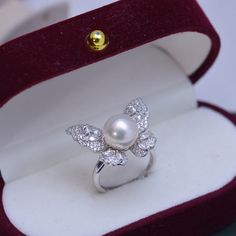 This elegant ring features a 9-10mm freshwater pearl and sparkling cubic zirconia, set in high-quality 4A freshwater pearl and gold vermeil. A stunning butterfly design adds a touch of whimsy, making it the perfect accessory for any occasion. Elevate your style with this sophisticated piece. Product Information Pearl Type Freshwater Pearl Origin China Shape Round Quality AAAA Size 9-10mm Nacre Very Thick Color White/Purple Luster Very High Pearl House, Pearl Jewelry Ring, Pearl Butterfly, Pearl Rings, Golden South Sea Pearls, Mabe Pearl, Purple Pearl, Cubic Zirconia Rings, Pearl Types