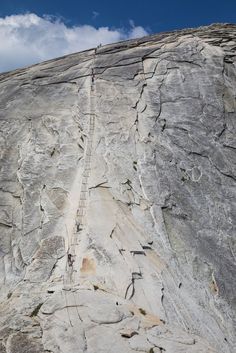 a man climbing up the side of a mountain