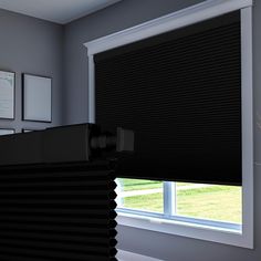 a room with a window covered in black blinds