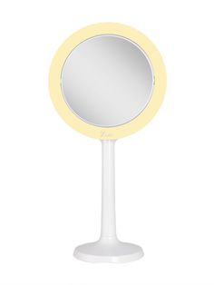 a white table with a yellow mirror on it