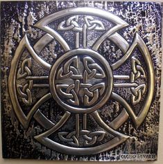 a metal plaque with an intricate design on it