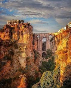 an old bridge built into the side of a cliff