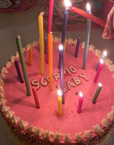 a birthday cake with lit candles on it