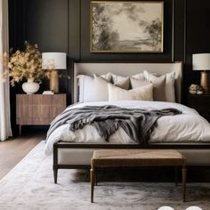 a bedroom with black walls and white bedding