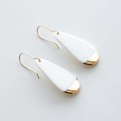 White earrings are handmade from porcelain and hand-painted with 24 k gold luster.  Perfect earrings to match your daily and occasion wear. Lightweight and very comfortable, you won't feel that you are wearing anything at all. Handmade 14 k gold-filled hooks are high quality - safe for most people with allergies and don't change color after time. Minimalist jewelry that will add unusual detail to your style. Unique design earrings and a great idea for a gift.  More designs available: https://www Jewelry Ceramic, Porcelain Earrings, Ceramic Earrings, Hand Painted Jewelry, Ceramic Earring, Porcelain Jewelry, Design Earrings, Earrings Minimalist, Gold Dipped