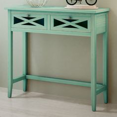 a blue console table with a bicycle on top