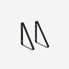 pair of black metal brackets against a white background with space for your text or image