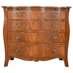 an antique chest of drawers with brass pulls and knobs on the top, against a white background