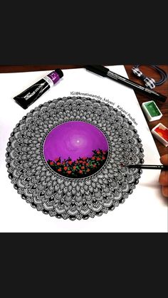 a drawing of a purple bowl on top of a white paper next to markers and pens